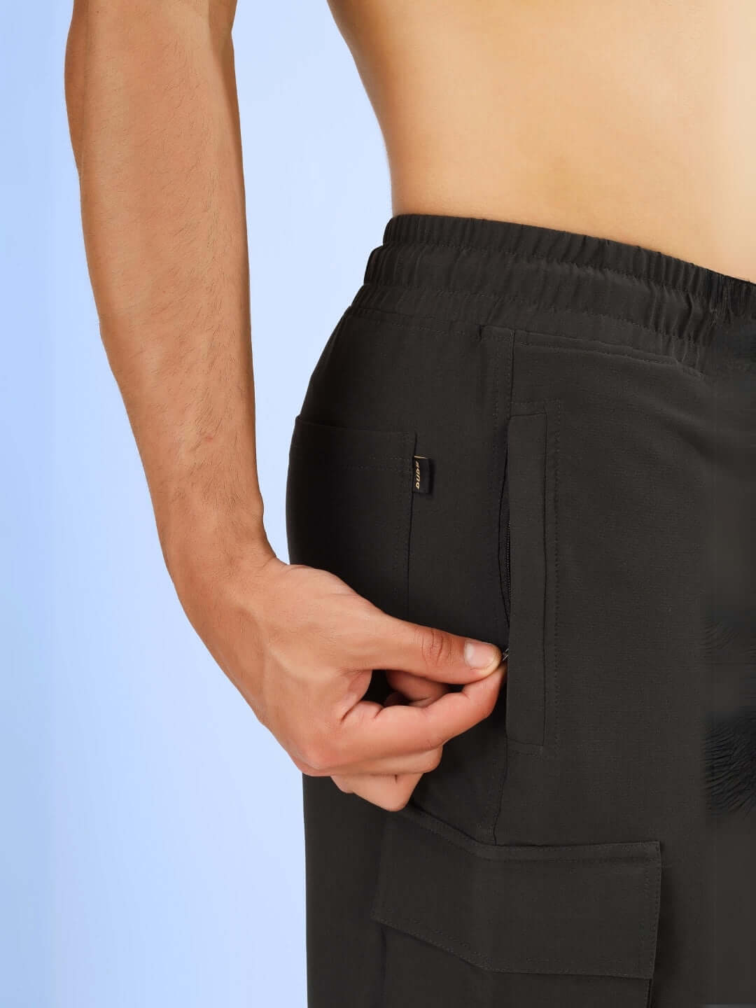 Side view of Brawny Cargo Shorts in dark grey, highlighting the pocket detail and customizable fit option for user preference.