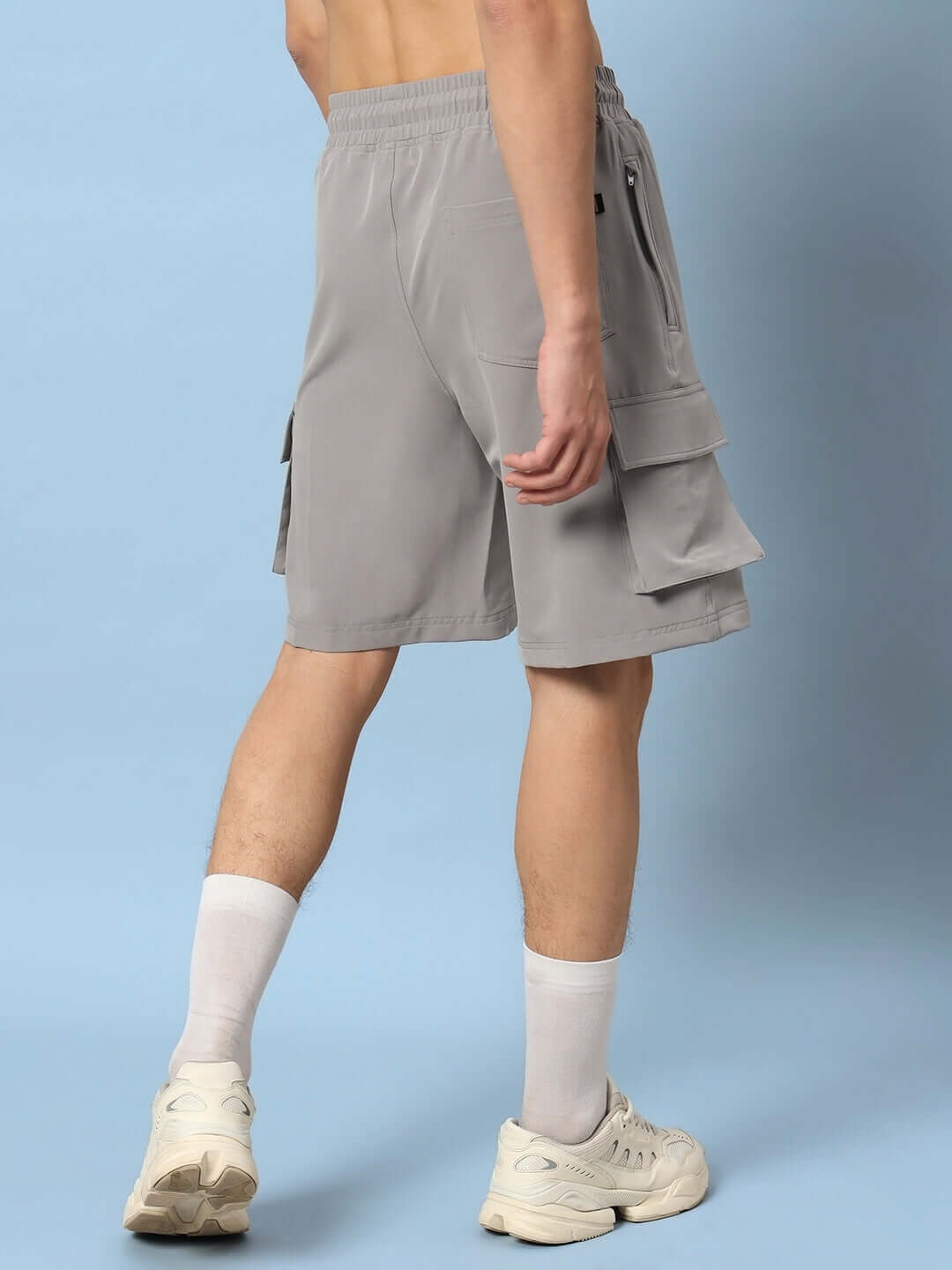 Rear view of model wearing grey Brawny Cargo Shorts showcasing multiple pockets and comfortable fit, ideal for outdoor activities.