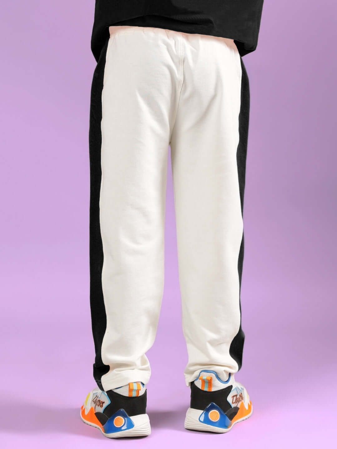 Off white-black jogger pants for boys and girls by DUDS, displayed on a purple background. Made-to-order customizable fit available.