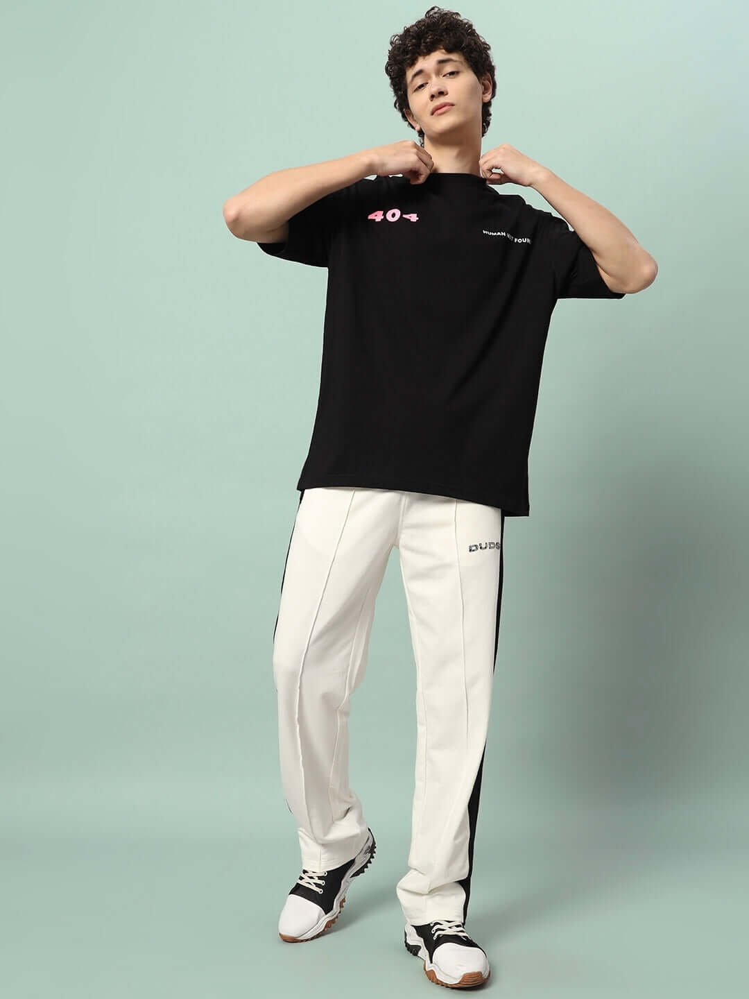 Model wears off-white black Breezer Side Contrast Joggers, styled with a black top, showcasing a casual and comfortable outfit.