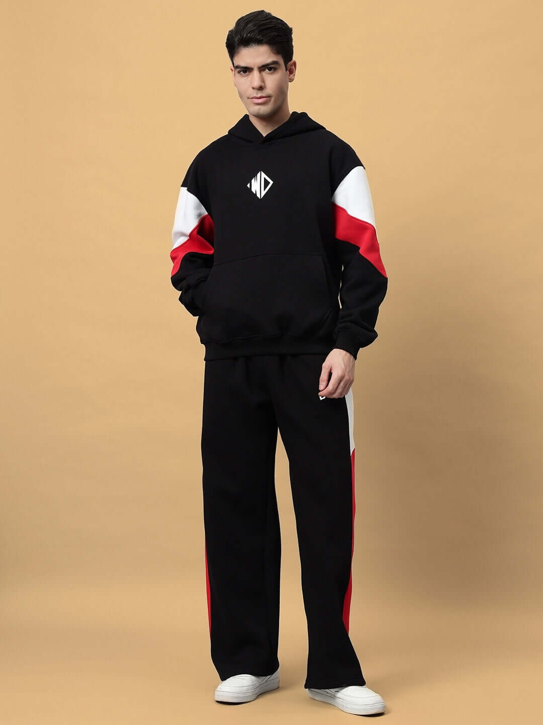 Model wearing BRIO FLEECE COLORBLOCK CO-ORD BLACK with colorblock panels, showcasing streetwear style and comfort.