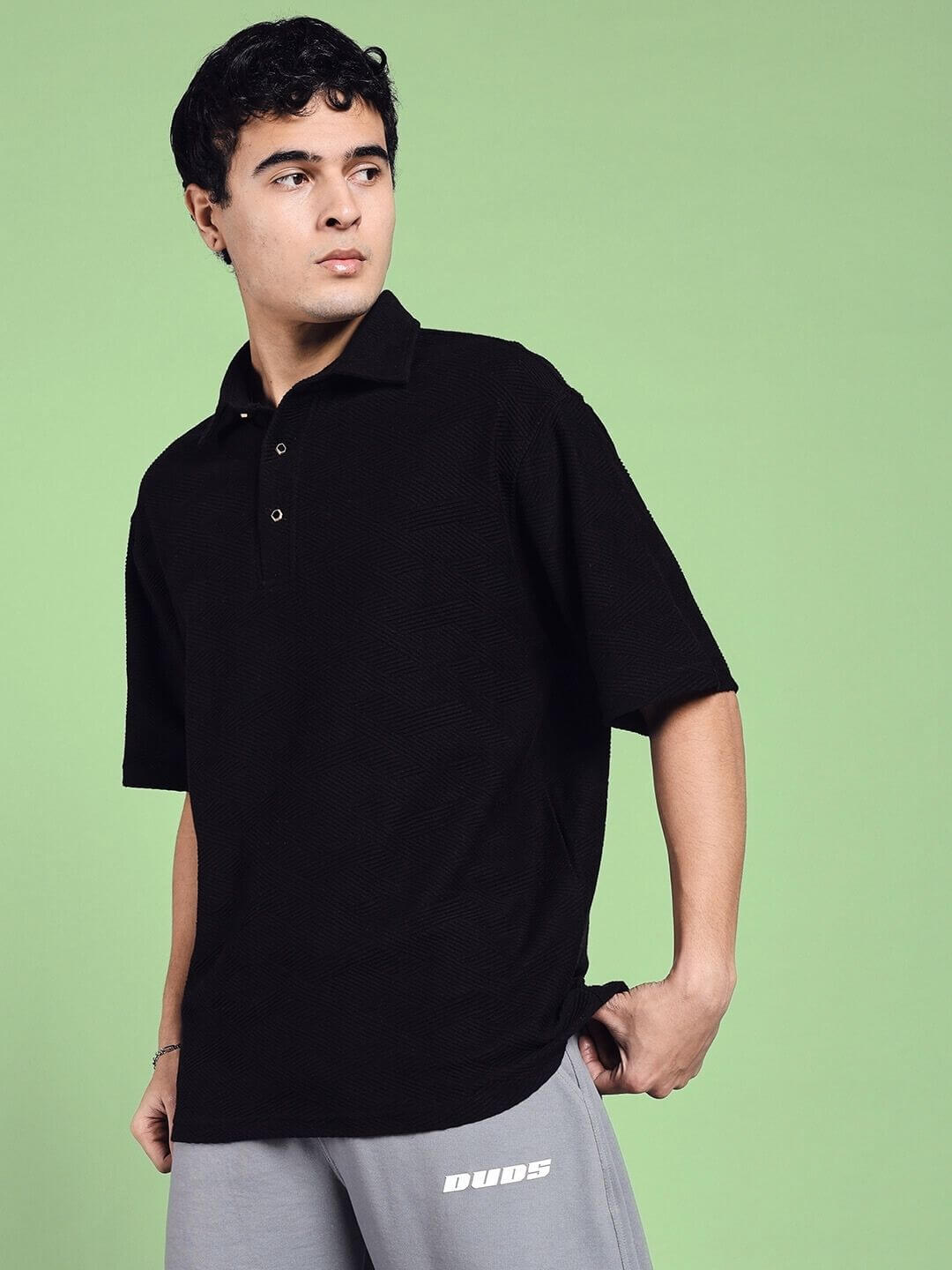 Man wearing BROCADE POLO COTTON T-SHIRT BLACK, stylish and comfortable with a classic polo design, in a casual setting.
