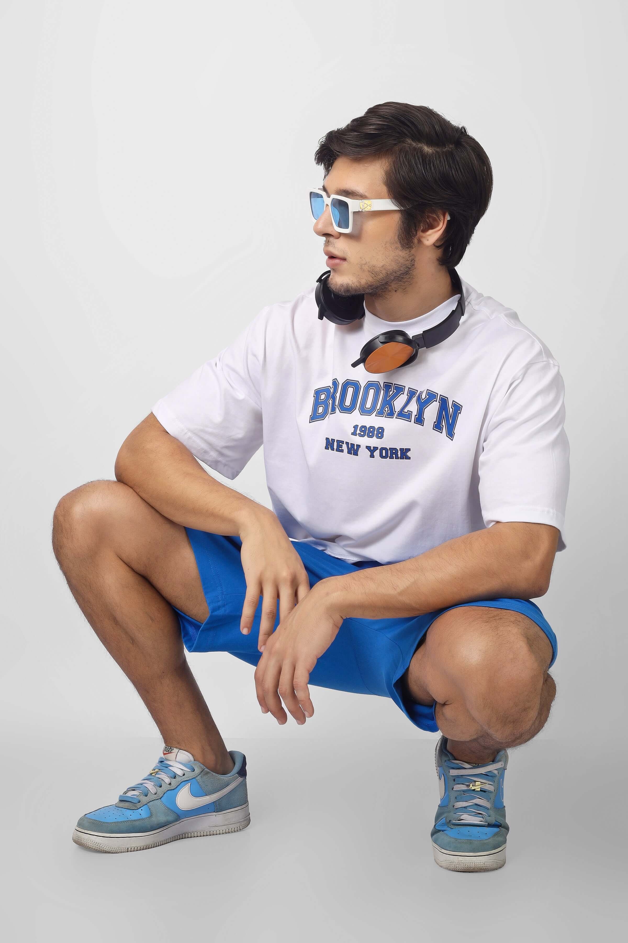 Casual style featuring Brooklyn Co-Ord Set in white and blue with headphones and sunglasses, showcasing urban fashion trends.