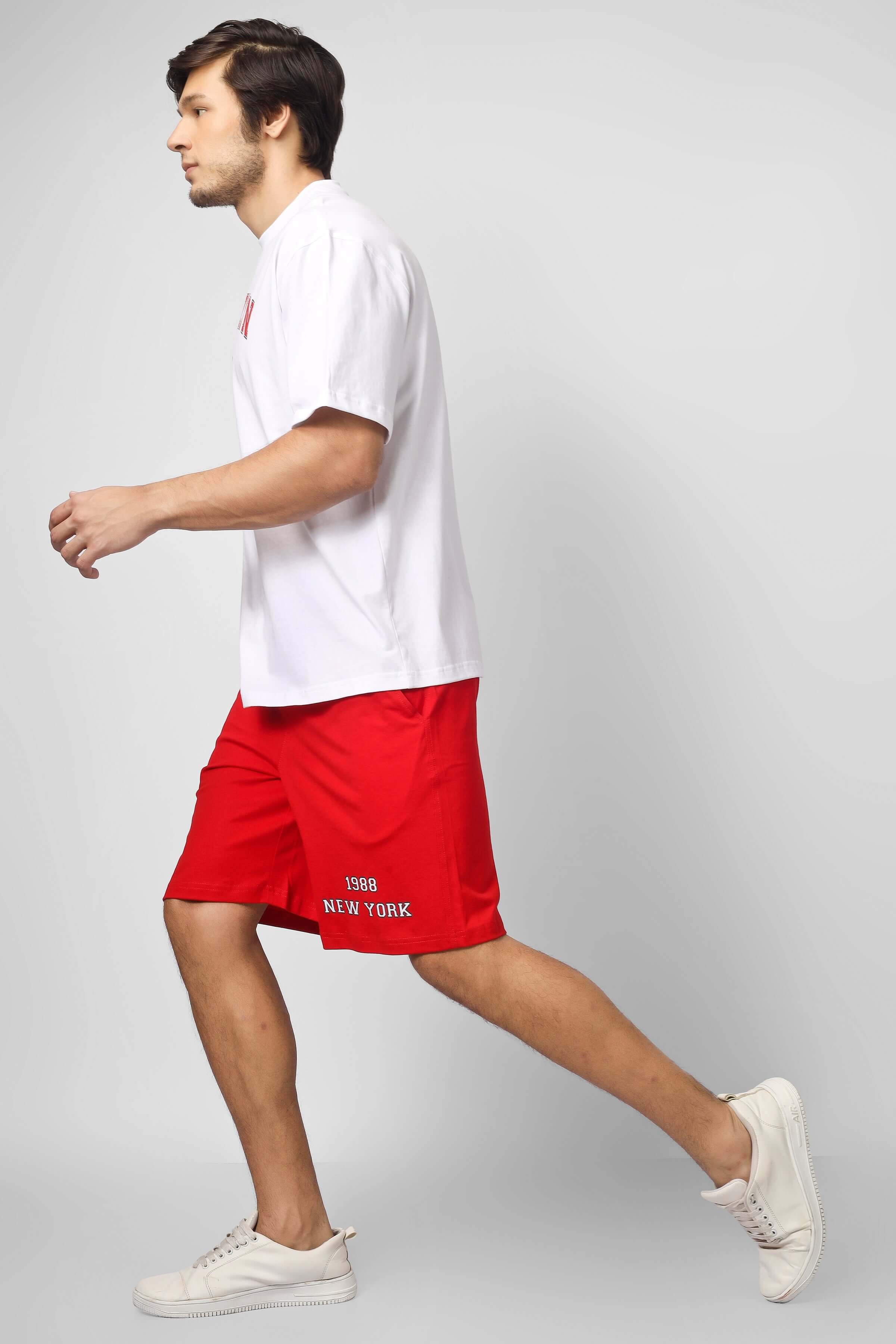 Man wearing Brooklyn Co-ord Set with white t-shirt and red shorts, provides Custom Fit option for tailored size. Ideal for casual outings.