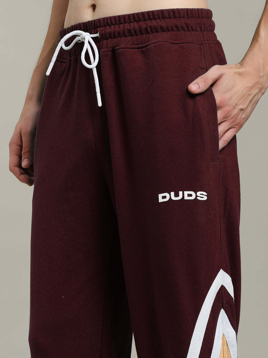 Model wearing RIO ONE Relaxed Fit Joggers in brown by DUDS, featuring a drawstring waistband and side pockets.