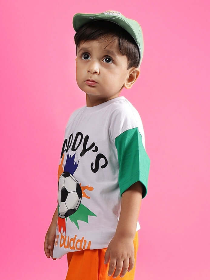 Child wearing Buddy Oversized T-Shirt for boys girls white, sporty design on pink background, casual unisex kids' tee style.