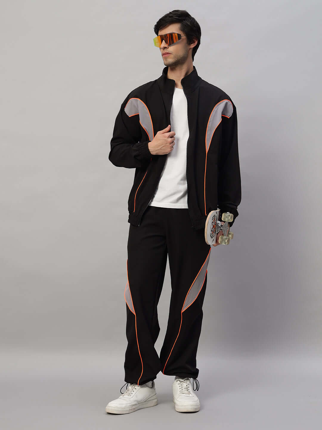 Model wearing BULLET OVERSIZED CO-ORD SET BLACK, holding a skateboard, showcasing streetwear fashion style, designed for comfort and athleisure.