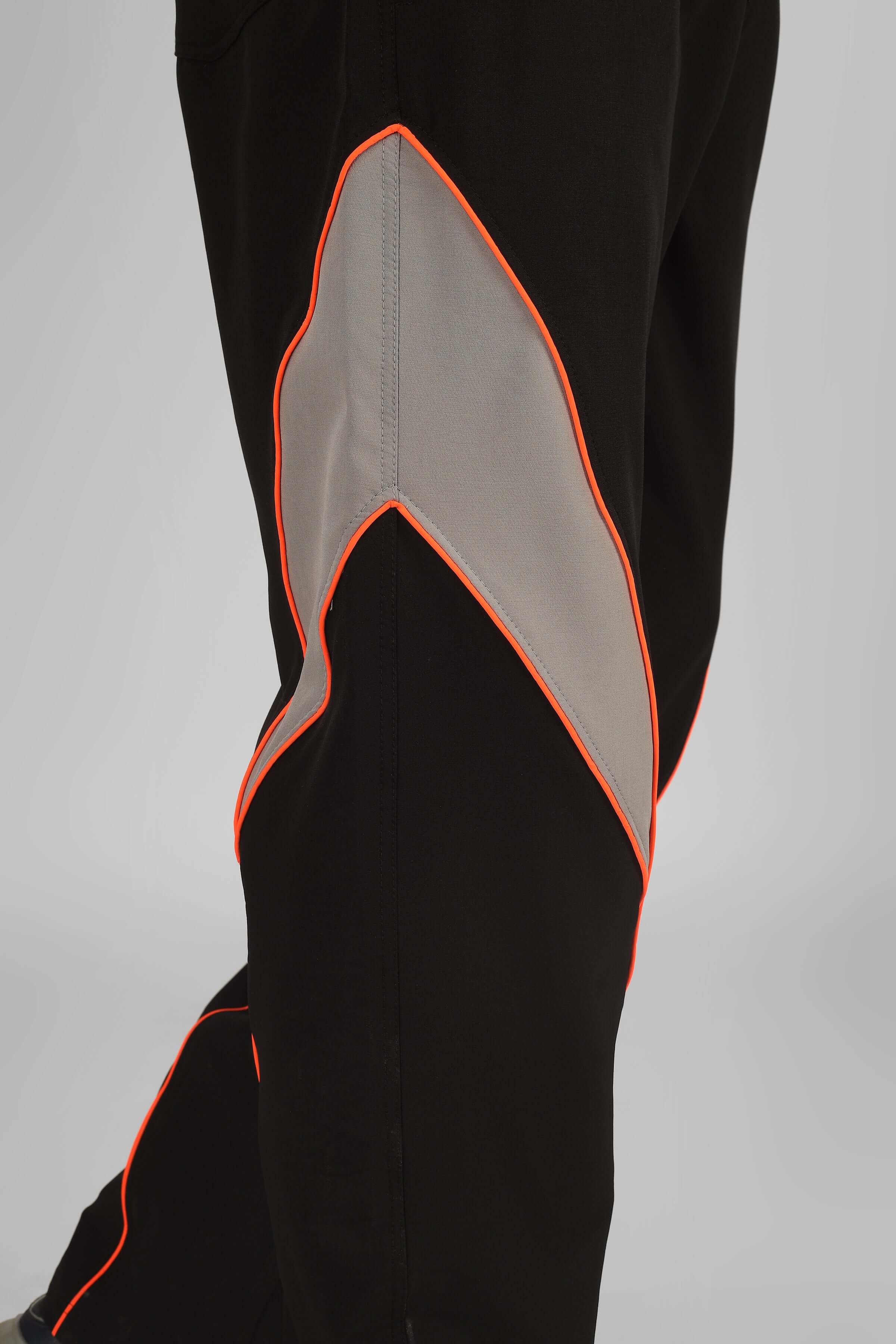Close-up view of Bullet Relaxed Fit Cargo Pants in black with unique orange and gray detailing.
