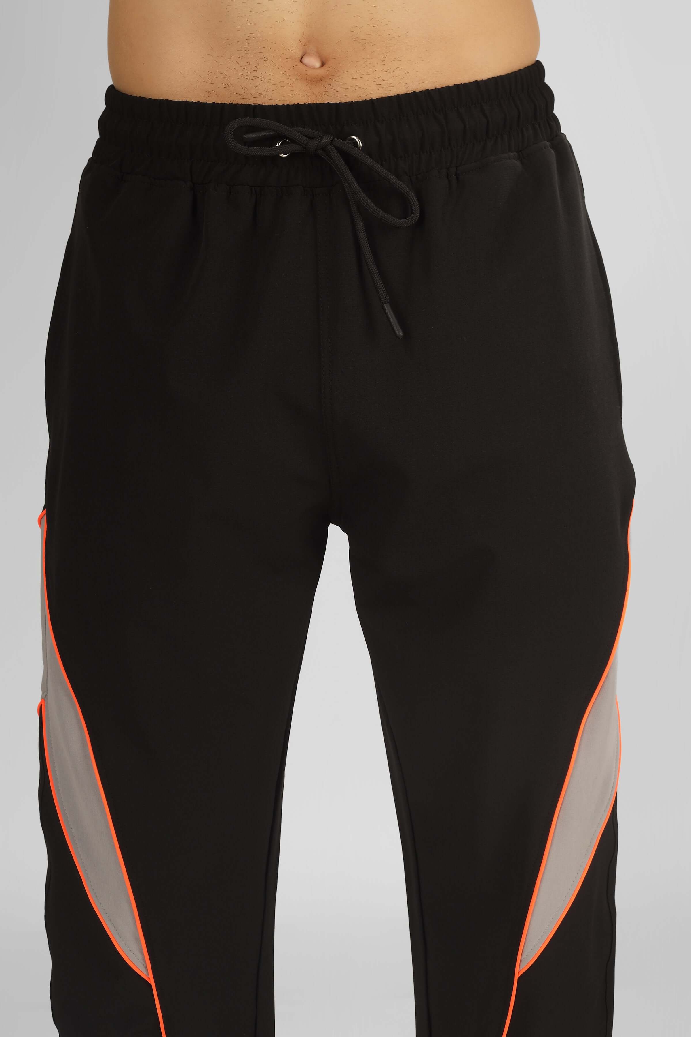 Black relaxed fit cargo pants with drawstring waist, featuring orange accents on sides.