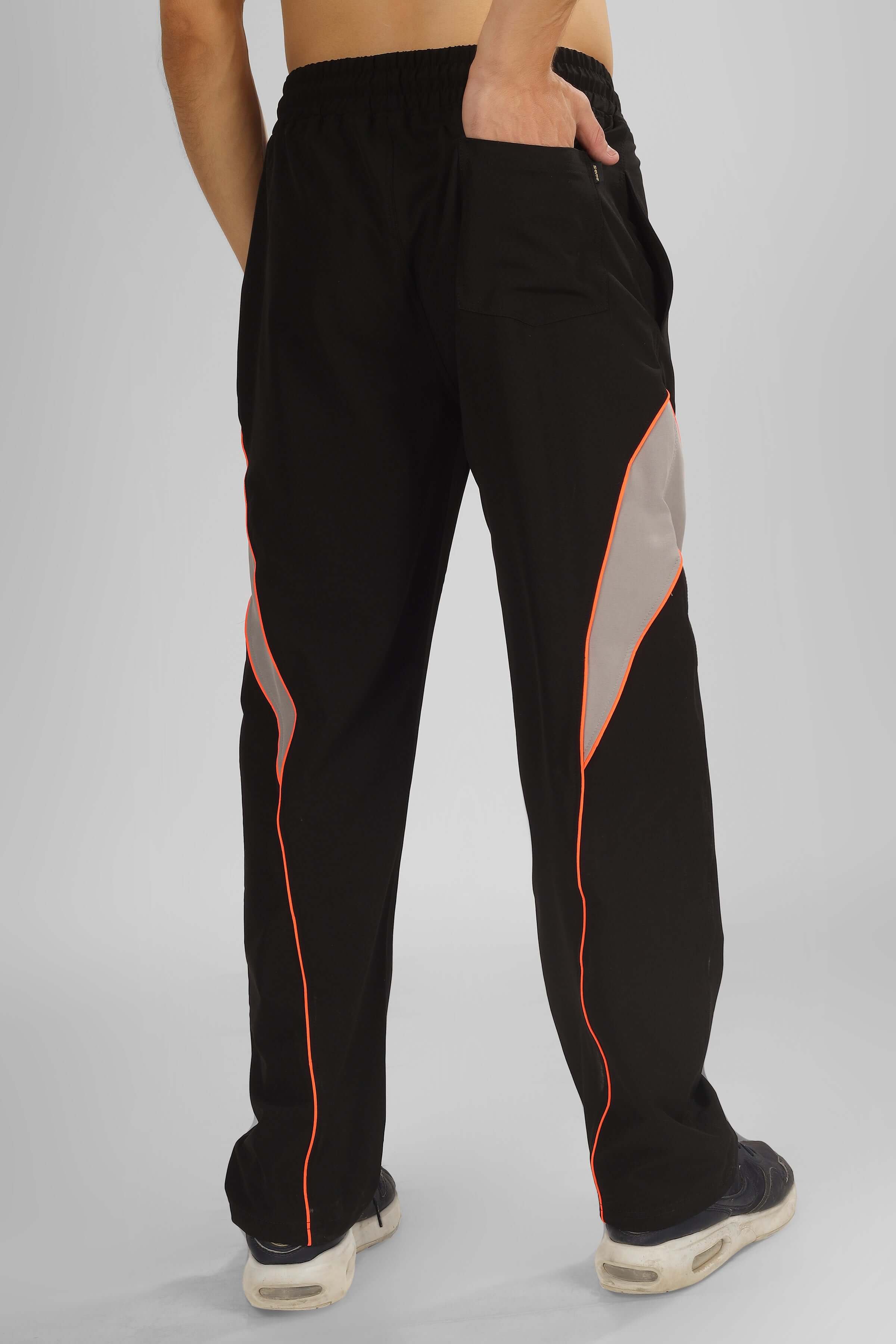 Back view of Bullet Relaxed Fit Cargo Pants in Black with orange trim, featuring customizable fit option for personalized sizing.