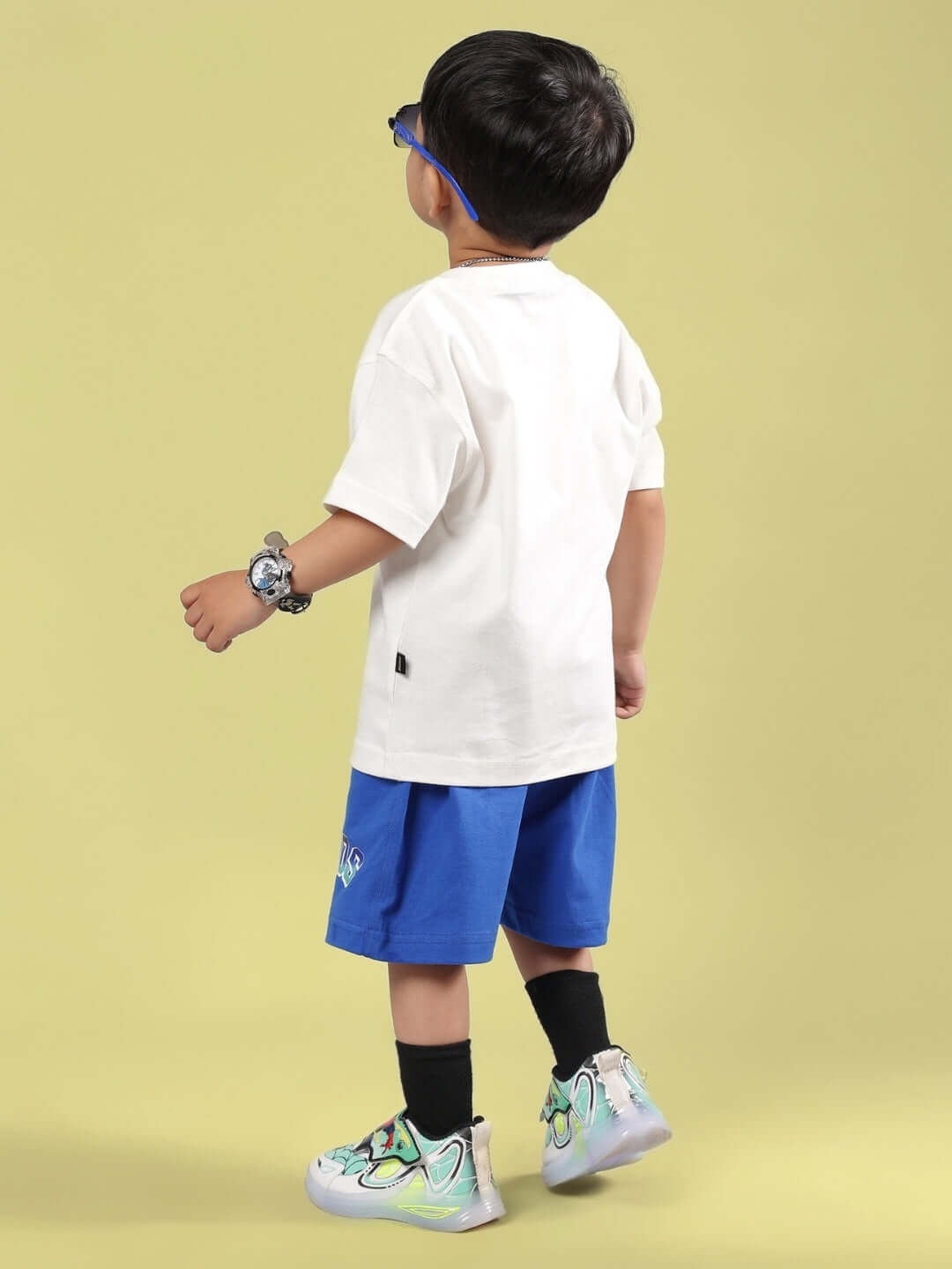 Child wearing Bumble Co-ord for Boys & Girls Off White-R Blue, featuring off white top and blue shorts; customizable, made-to-order clothing.