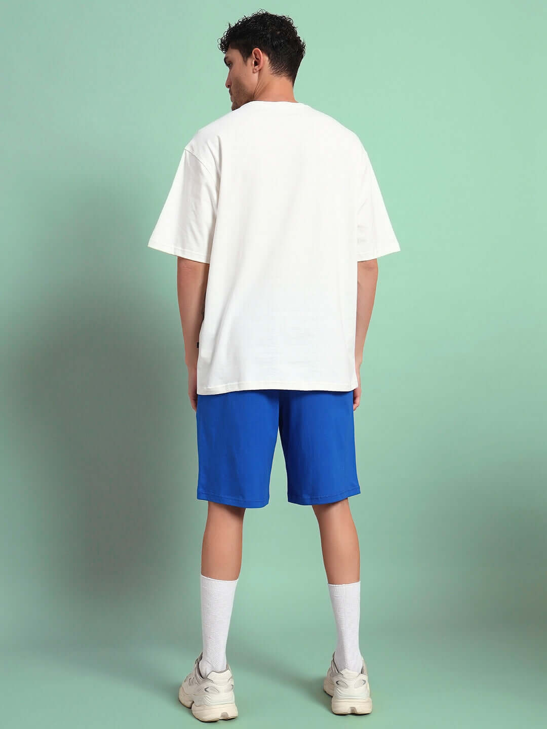 Man wearing BUNNY BUGS CO-ORD SET OFF-WHITE BLUE, featuring off-white t-shirt and blue shorts made of premium cotton French Terry Lycra.