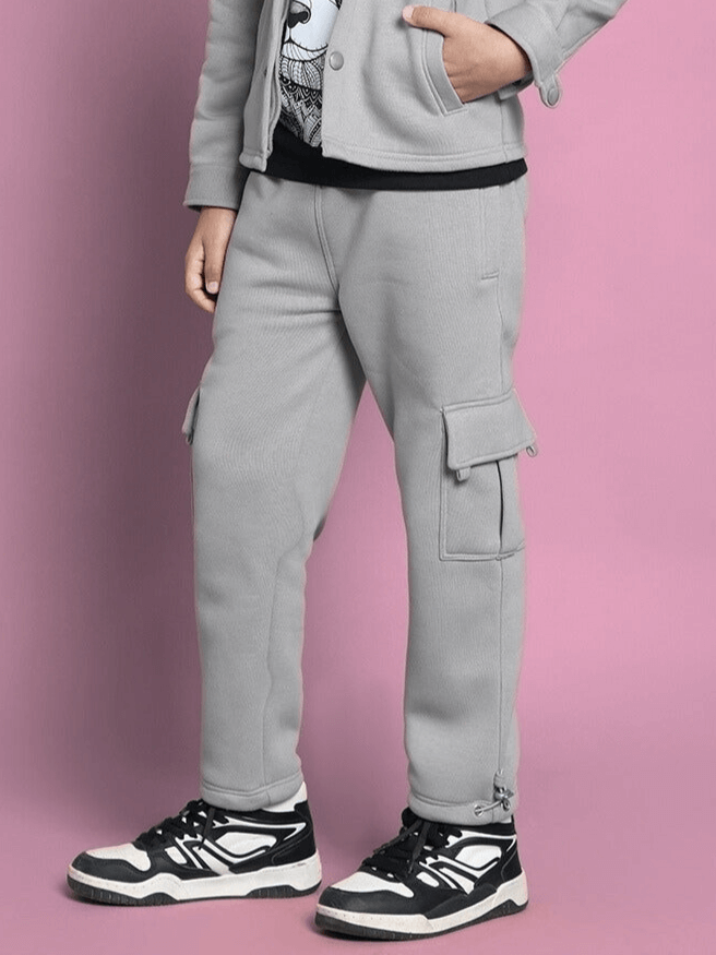 Grey Burly Fleece Pant for boys and girls with side pockets, shown on a model in casual setting.