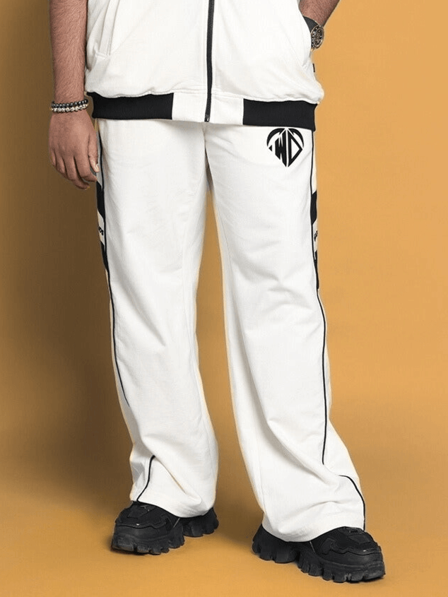 Man wearing CALEDONIA JOGGERS in off white with black accents, showcasing relaxed fit and stylish design. Ideal for custom fit orders.