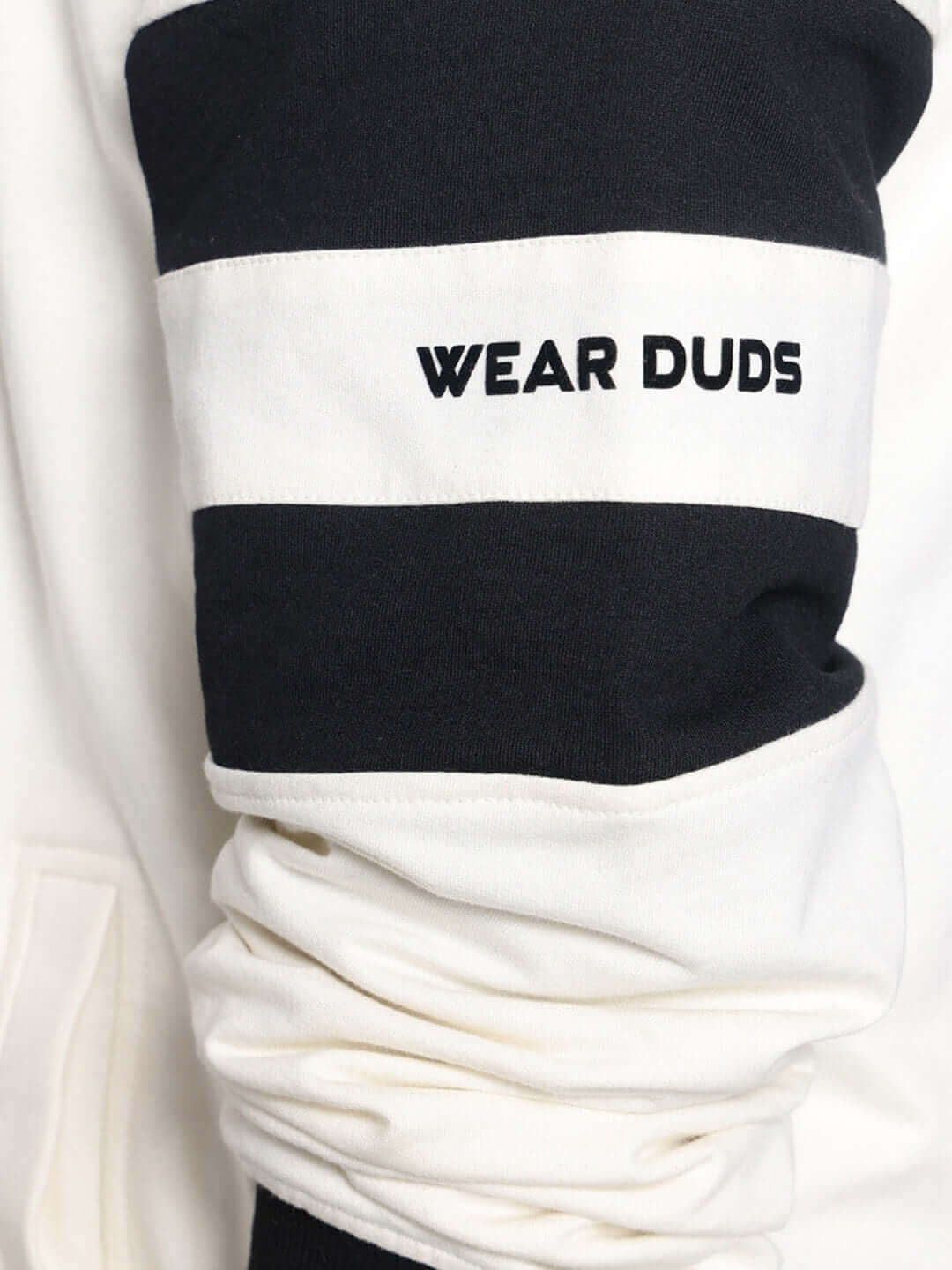 Close-up of CALEDONIA CO-ORD SET sleeve in off-white cotton terry fabric, displaying 'Wear Duds' text in contrasting black.