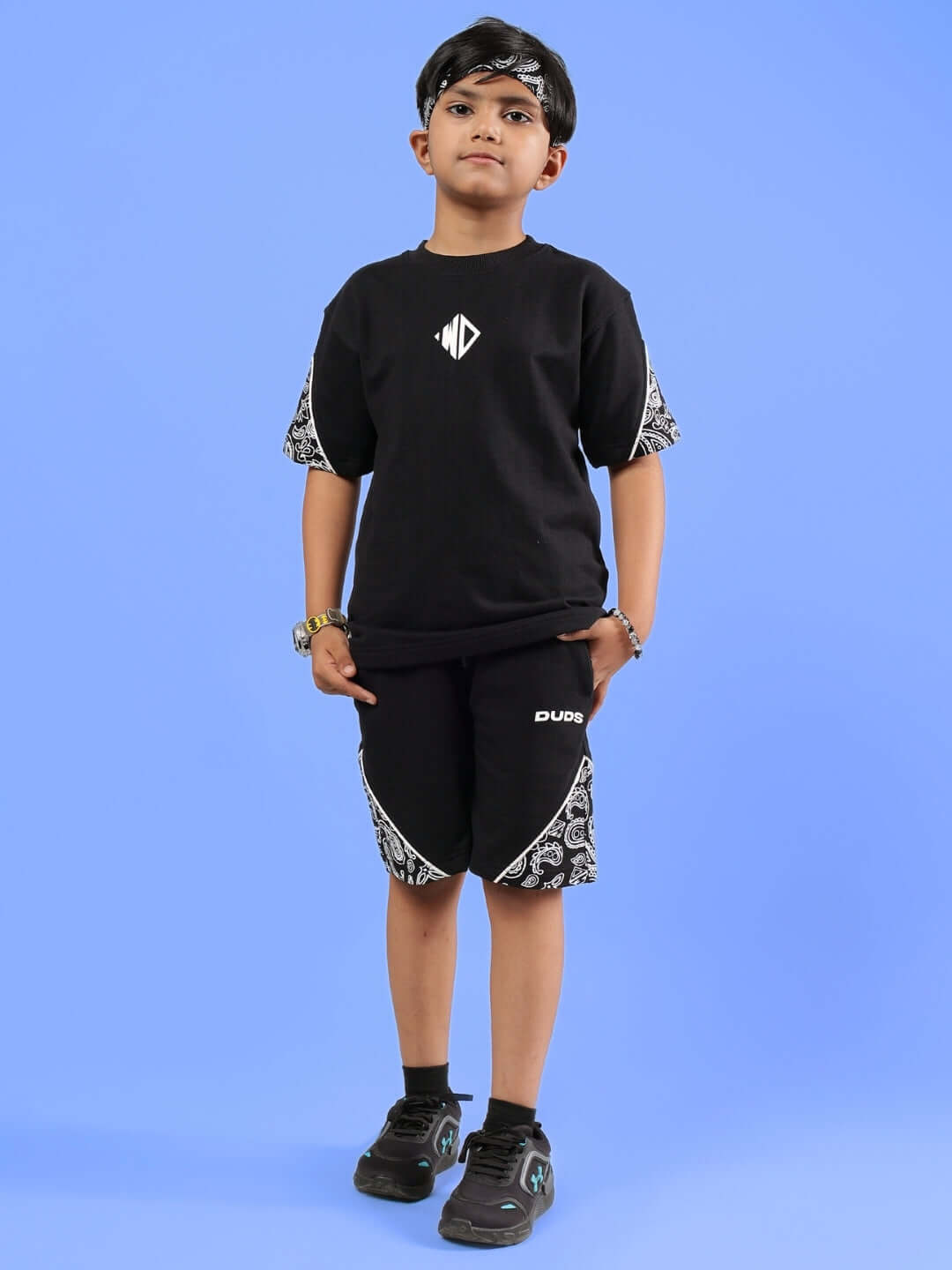 CALVIN CO-ORD FOR BOYS & GIRLS BLACK set, featuring a trendy kid in a stylish black outfit on a blue background.