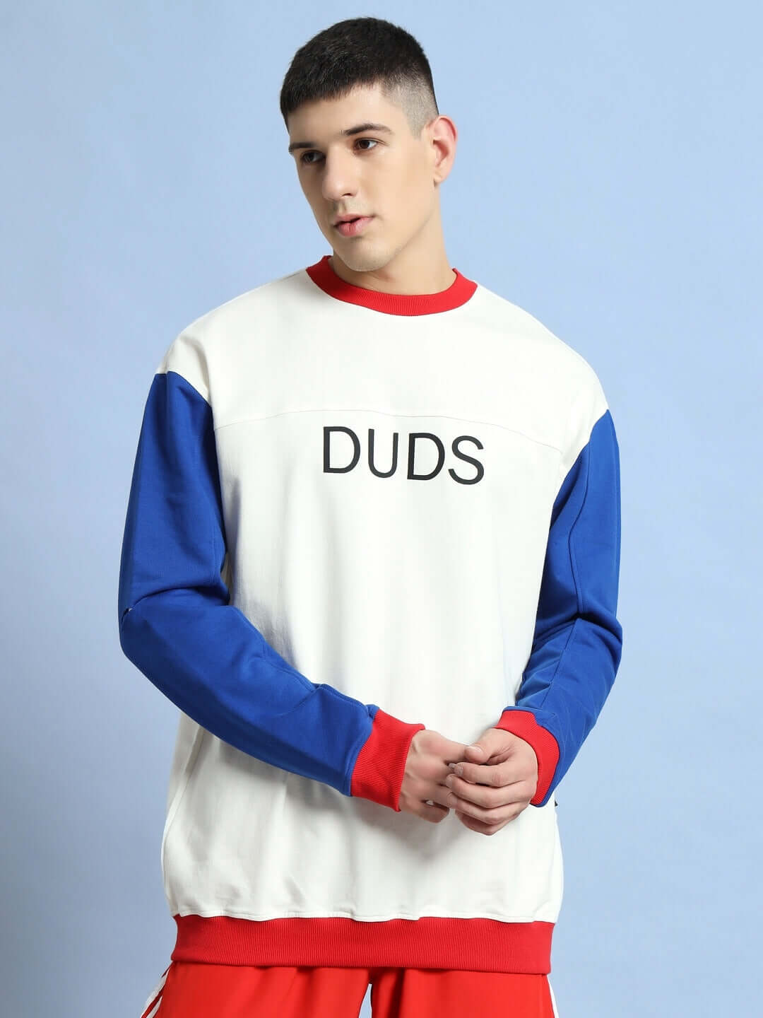 Model wearing Candy Crush oversized sweatshirt in multi-color with bold 'DUDS' print, featuring premium cotton and elastane blend.