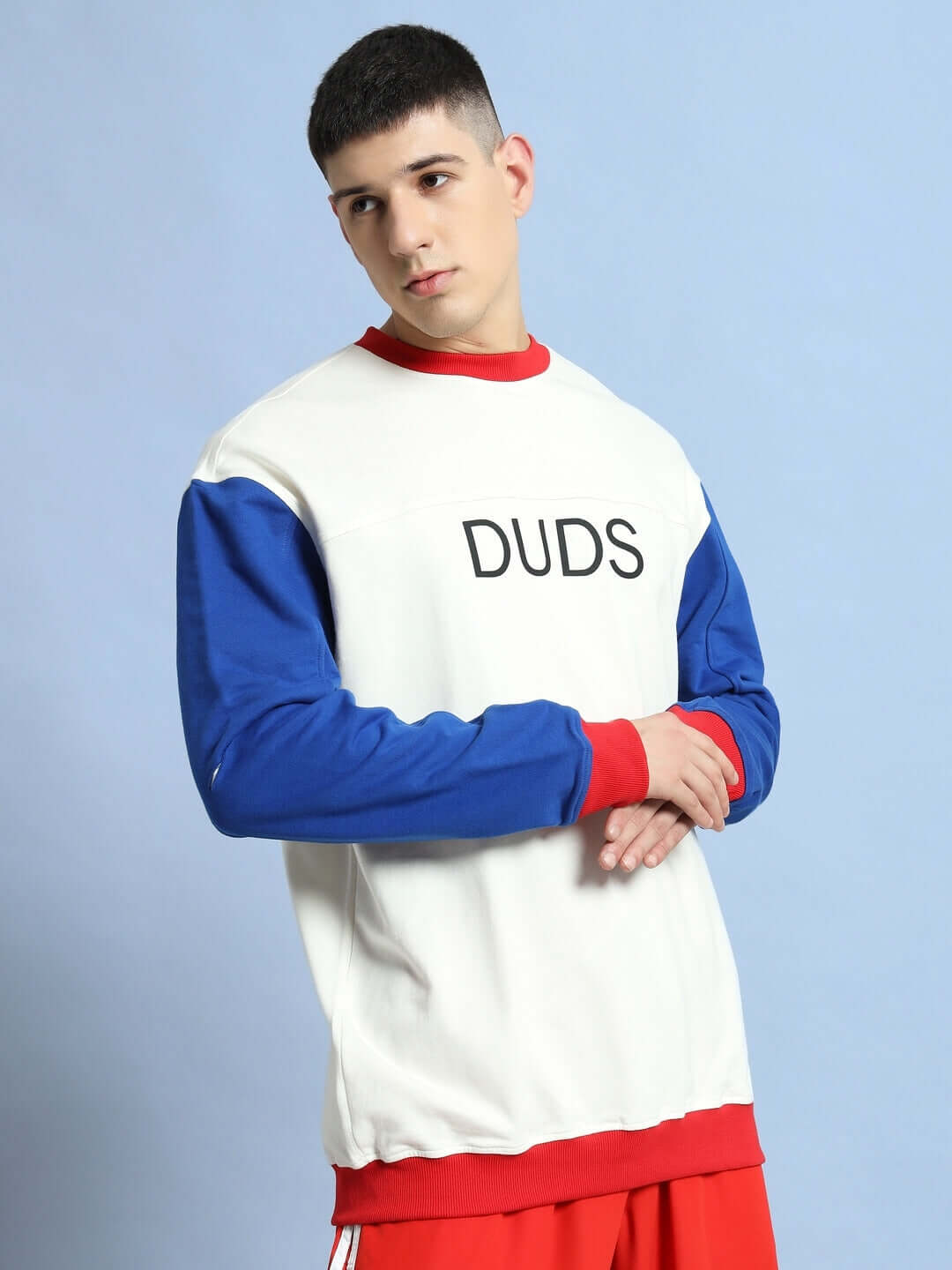 Model wearing Candy Crush Oversized Sweatshirt in multi-color with 'DUDS' text, made from premium cotton blend, against a light blue background.