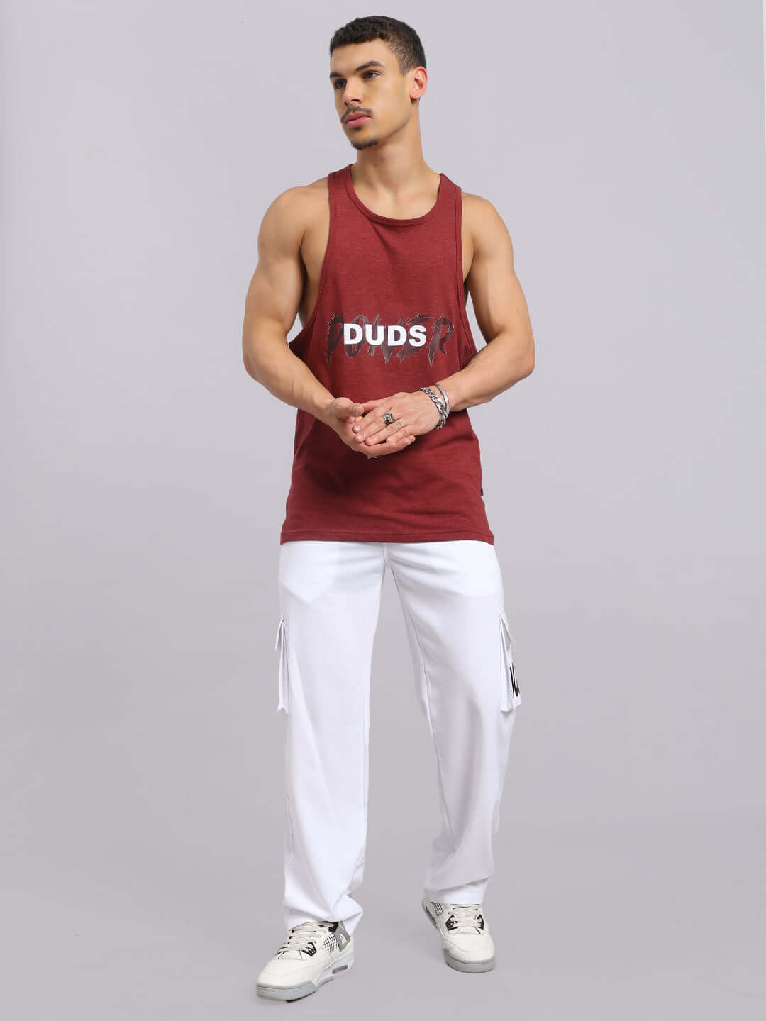 Model wearing Carmine Relaxed Fit Jogger in White by DUDS, paired with a maroon tank top. Tailored for comfort and style.