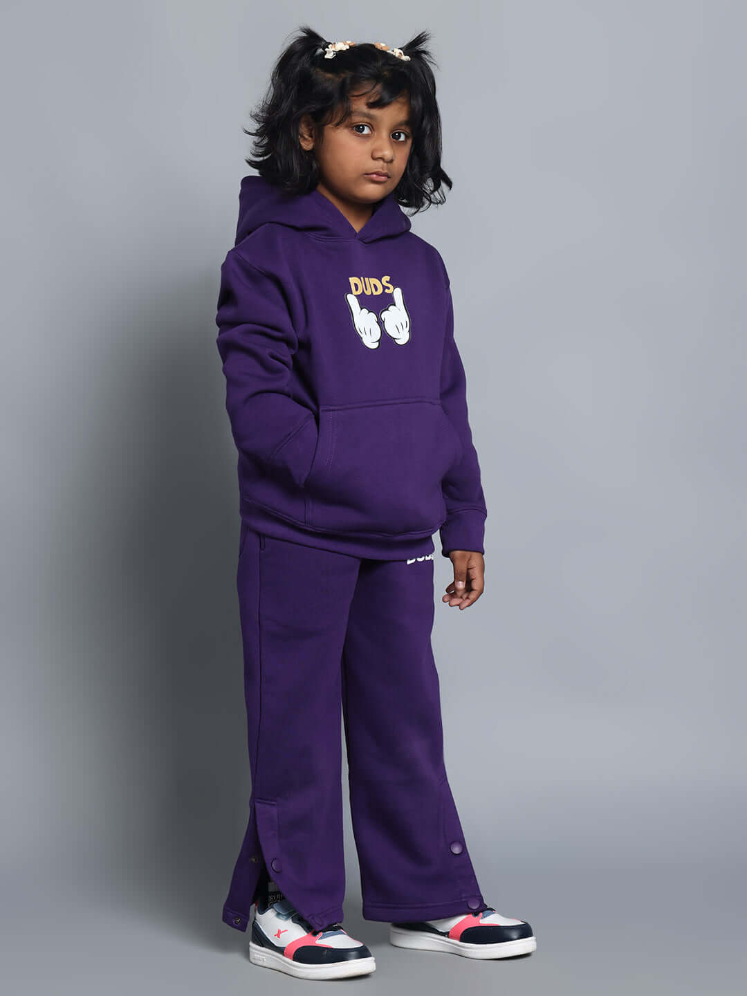 Child wearing CASPER FLEECE PANT FOR BOYS GIRLS PURPLE, displaying cozy style and comfort, paired with a matching hoodie.