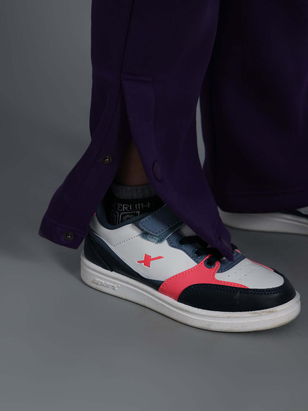 Model wearing CASPER FLEECE PANT FOR BOYS GIRLS PURPLE with sneakers