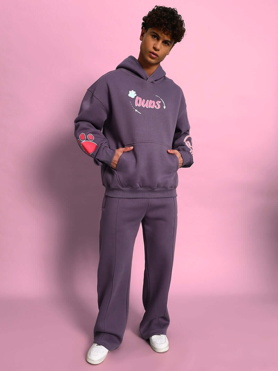 Model wearing CASPER COTTON FLEECE CO-ORD VIOLET with hoodie and joggers against pink background