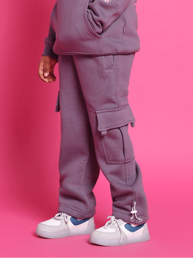 Casper fleece pants for boys and girls in violet, featuring cargo pockets, perfect for casual wear, shown with white sneakers.