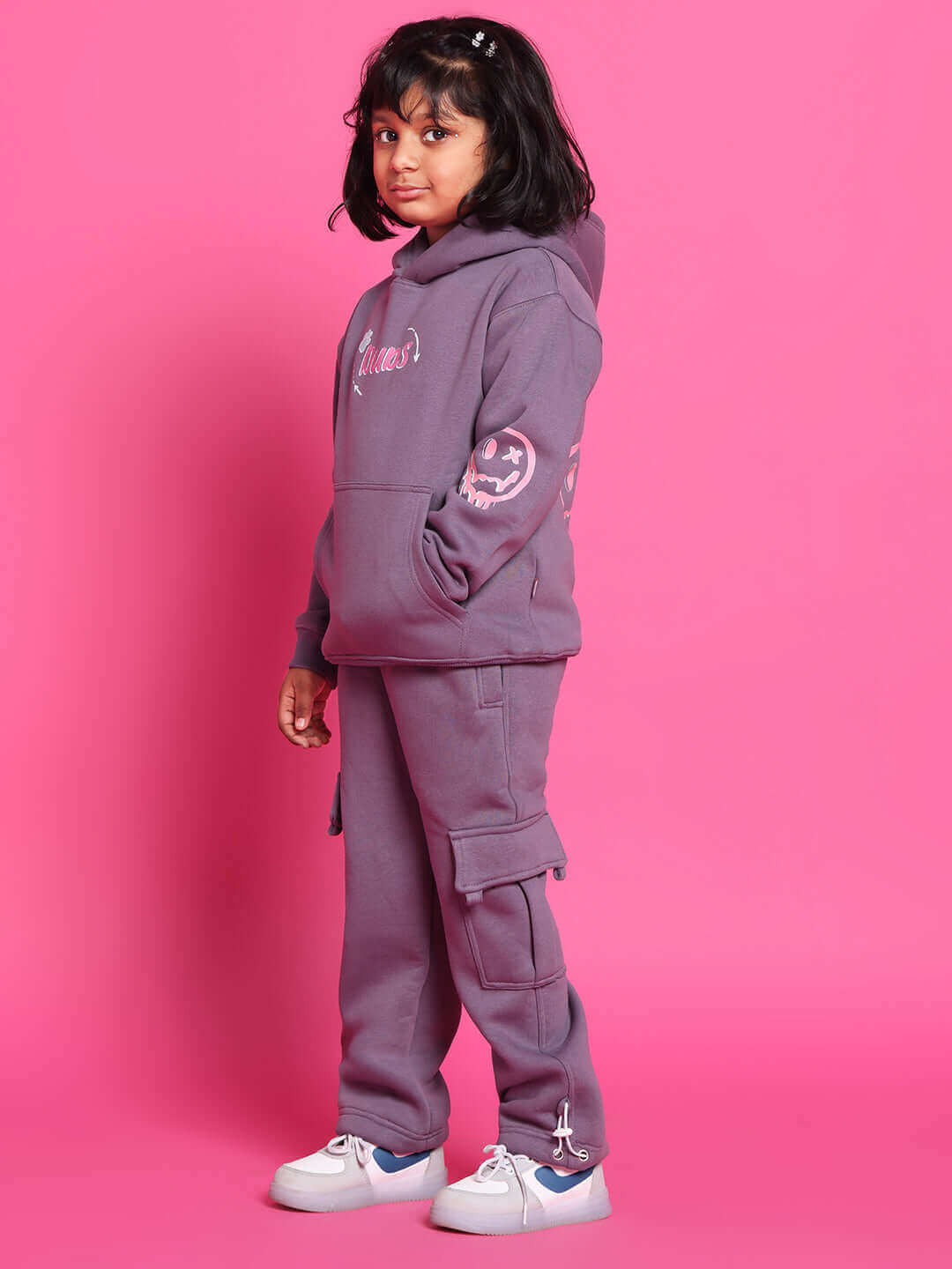 Child wearing violet CASPER Co-Ord set against pink background, showcasing cozy and stylish outfit by DUDS.