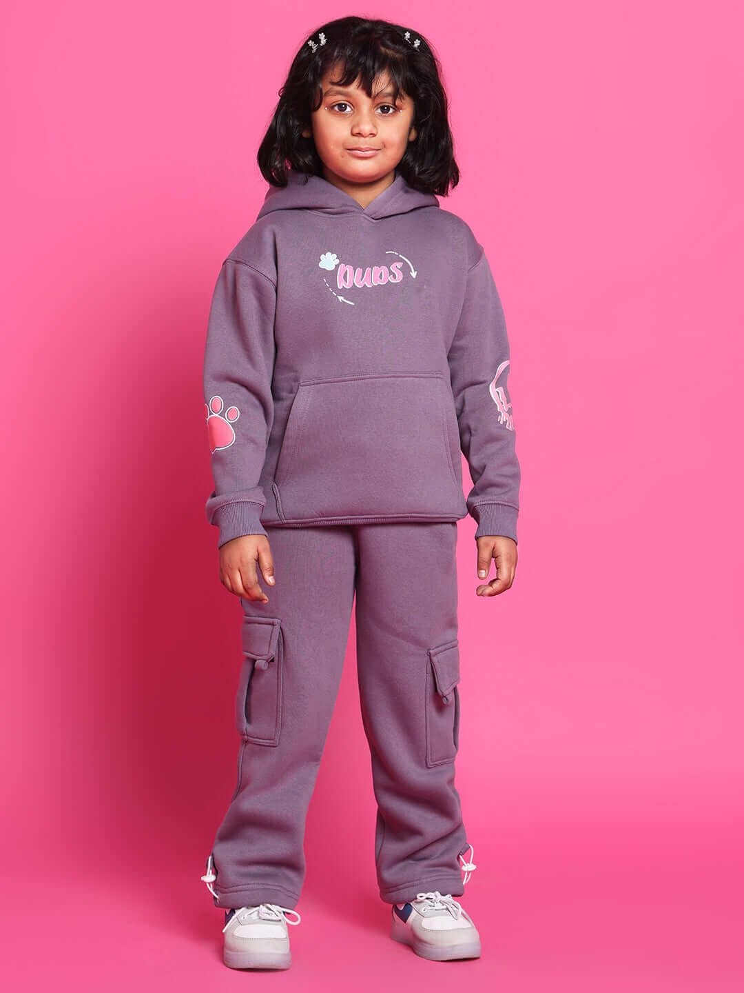 Child wearing violet Casper Co-Ord set with hoodie and cargo pants, designed by DUDS, against pink background.