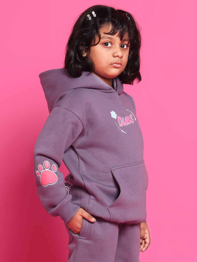 Child wearing violet CASPER CO-ORD outfit from DUDS with hoodie and paw print design, suitable for boys and girls.