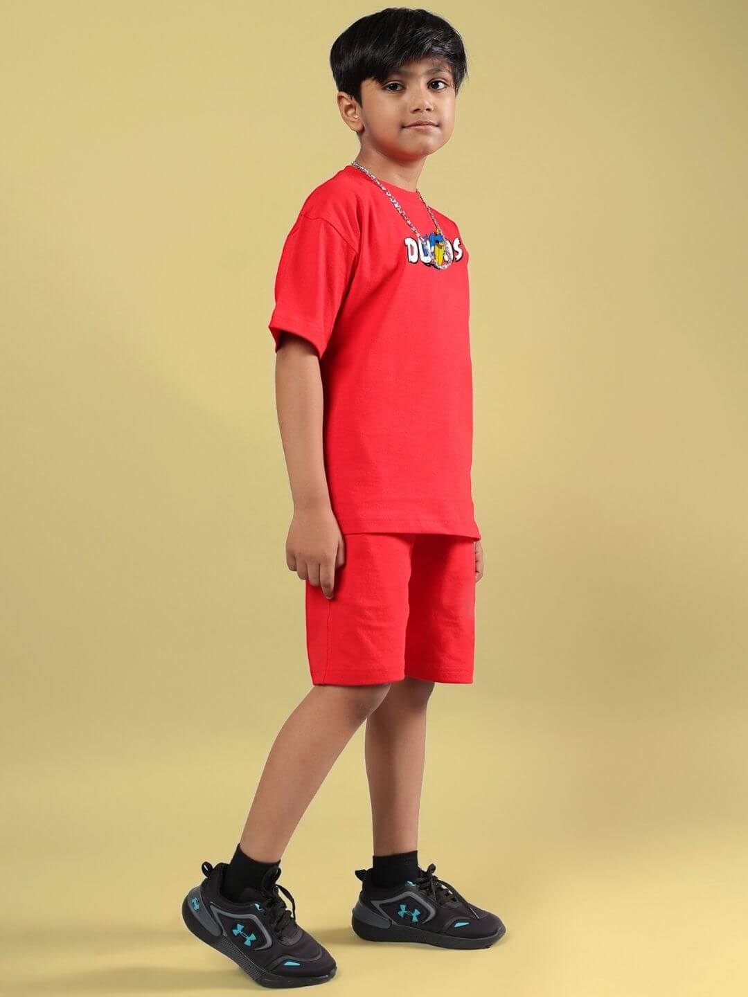 Boy wearing CATCH THE WAVES CO-ORD FOR BOYS & GIRLS RED, featuring a red tee and shorts set, ideal for stylish and comfortable kids' fashion.