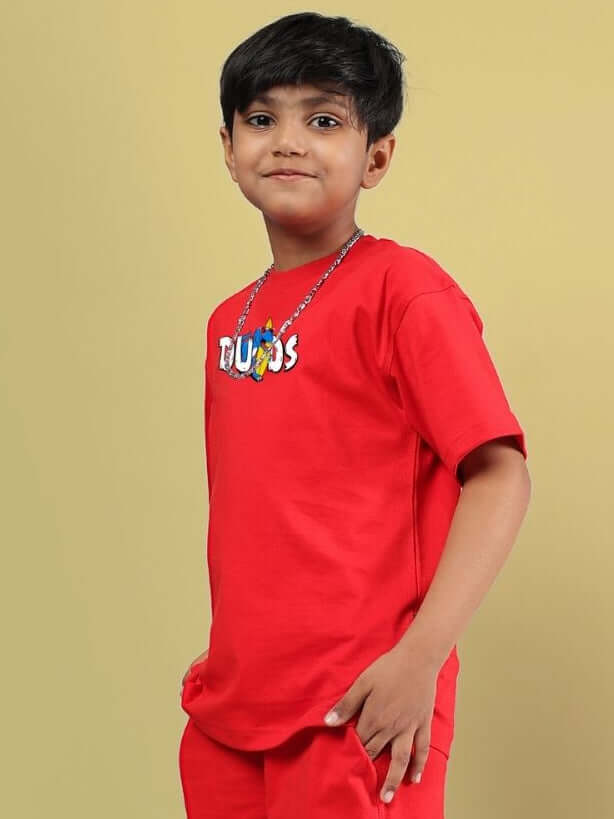 Boy wearing CATCH THE WAVES T-SHIRT FOR BOYS GIRLS RED, striking red tee, kids fashion, premium cotton, adventure spirit.
