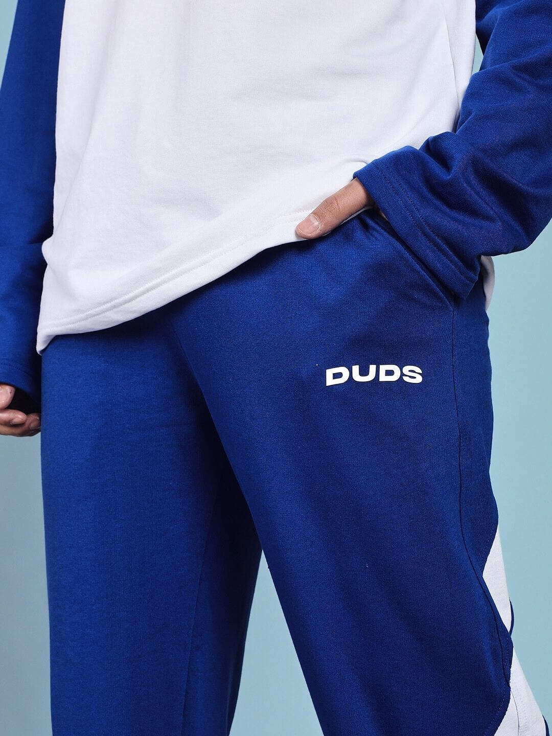 Woman wearing CELESTINE COOL RELAXED FIT CO-ORD SET WHITE BLUE with comfortable blue pants and white top, featuring chic athleisure style.