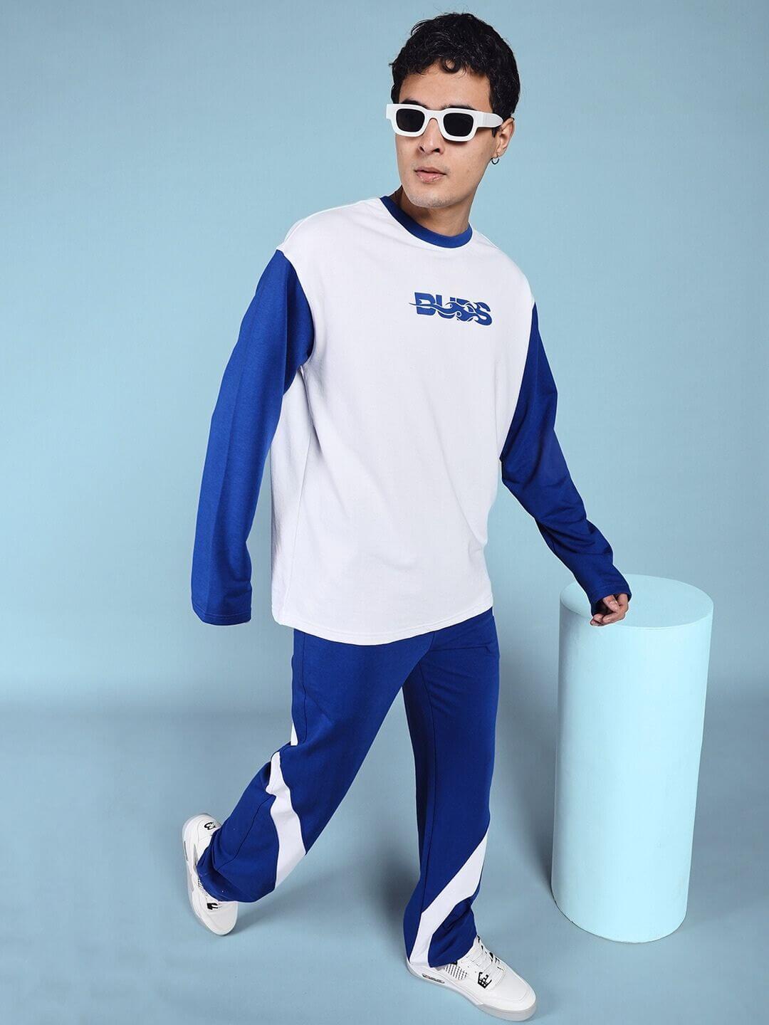 Alt Tag: Model wearing CELESTINE COOL RELAXED FIT CO-ORD SET WHITE BLUE in a stylish pose against blue background.