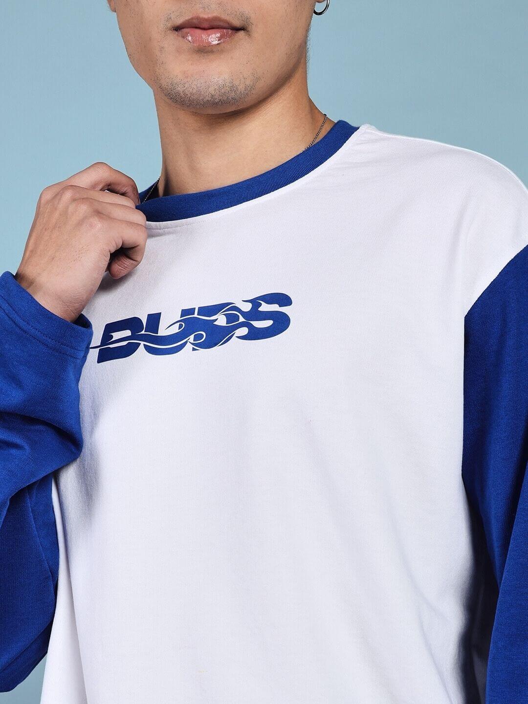 Model wearing CELESTINE COOL RELAXED FIT CO-ORD SET WHITE BLUE top with blue sleeves and logo, showcasing chic and comfortable athleisure.