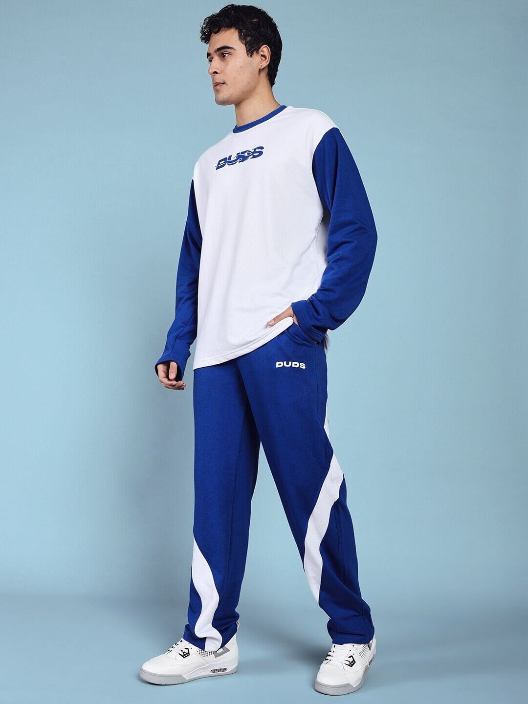 Model wearing Celestine Cool Relaxed Fit Co-ord Set White Blue, showcasing chic and comfortable athleisure style in breathable fabric.