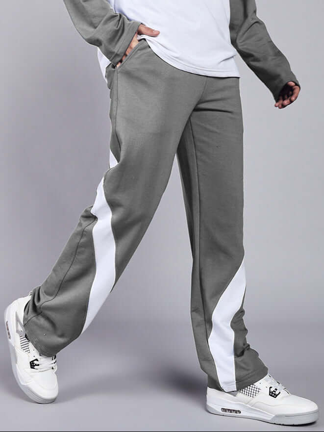 Stylish grey white Celestine relaxed fit joggers with white stripe detail, made by DUDS, worn with matching sneakers.