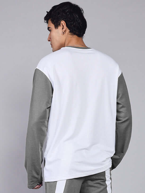 Back view of a man wearing CELESTINE COOL SWEATSHIRT WHITE GREY, showcasing its white base and grey sleeves, perfect for modern style.