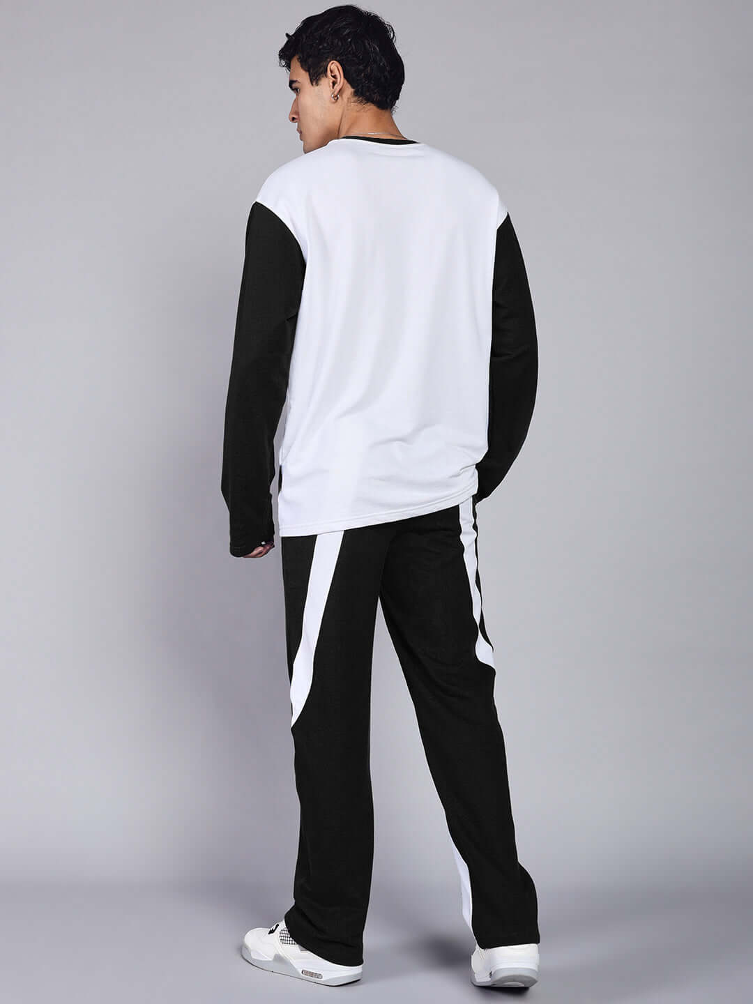 Back view of CELESTINE COOL RELAXED FIT CO-ORD SET WHITE-BLACK worn by model, showcasing the stylish two-piece outfit with crisp white and bold black accents.