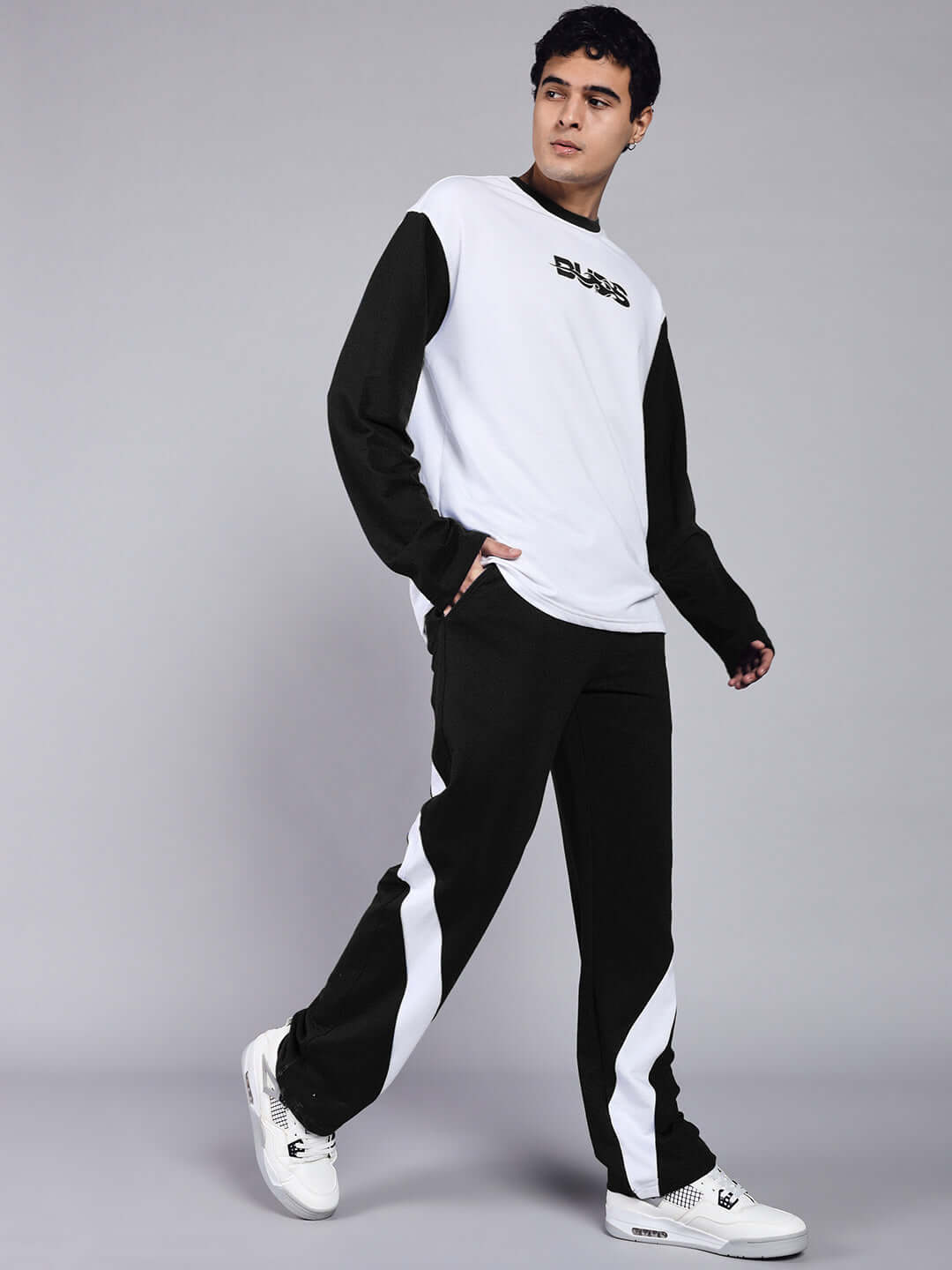 Model wearing CELESTINE COOL RELAXED FIT CO-ORD SET WHITE-BLACK, showcasing modern streetwear style with bold black and white design.