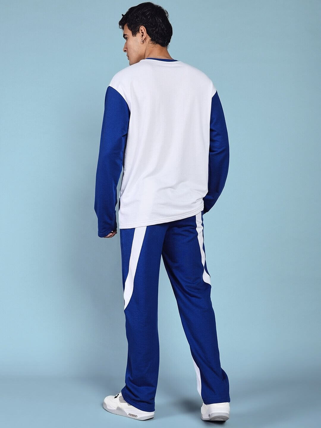 Man wearing CELESTINE COOL RELAXED FIT CO-ORD SET WHITE BLUE, showcasing back view in stylish athleisure outfit.
