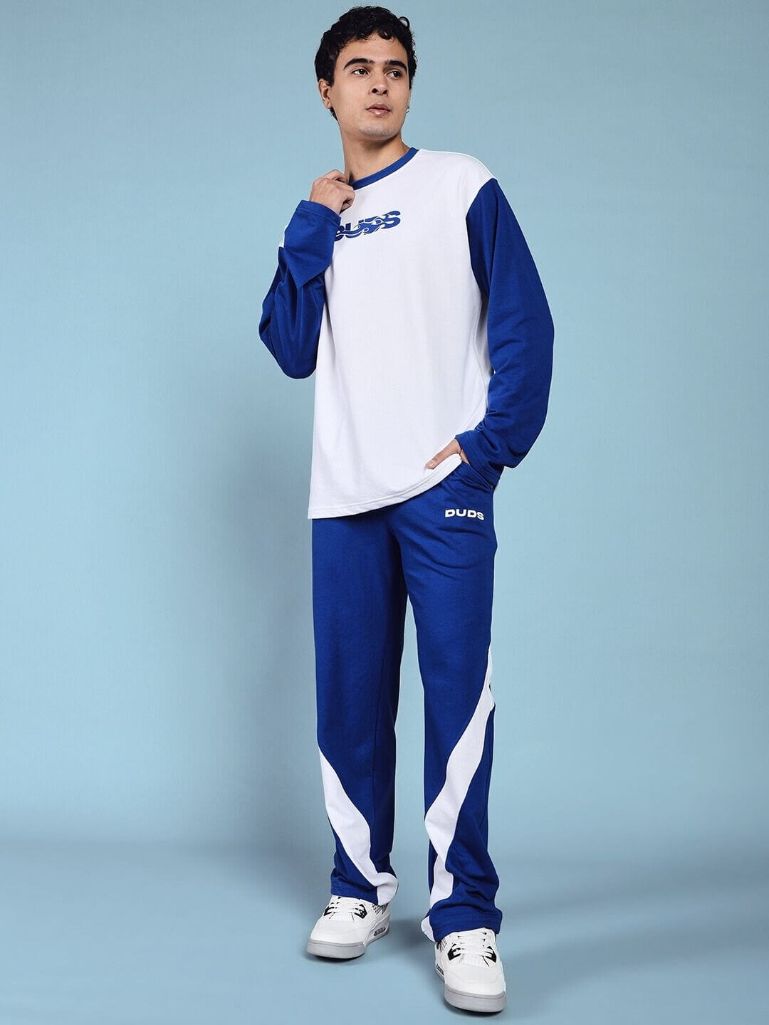 Man wearing CELESTINE COOL RELAXED FIT CO-ORD SET WHITE BLUE standing confidently against light blue background.