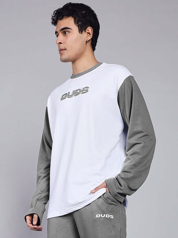 Man wearing CELESTINE COOL SWEATSHIRT WHITE GREY with grey sleeves, featuring a relaxed casual look against a neutral background.