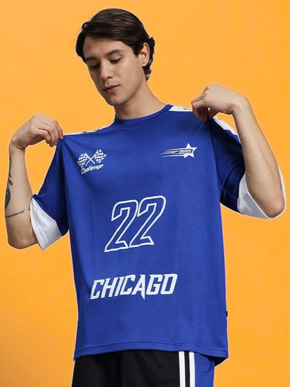 Man wearing CHALLENGE OVER-SIZED T-SHIRT ROYAL BLUE with Chicago logo, displaying front design.