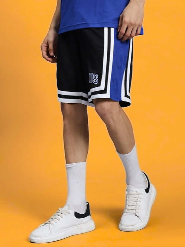 Model wearing CHALLENGE REGULAR FIT SHORTS R BLUE, unisex style ideal for active play and sports, showcasing comfort and durability.