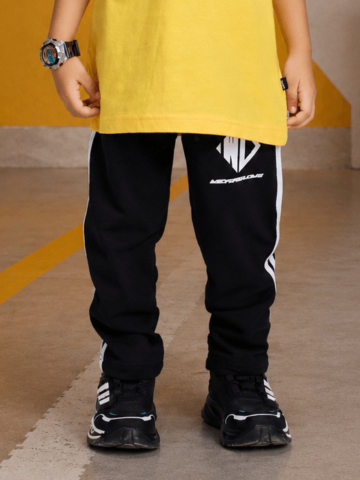CHAMPION TRACK JOGGER FOR BOYS GIRLS BLACK worn by a child with a yellow shirt and stylish sneakers.