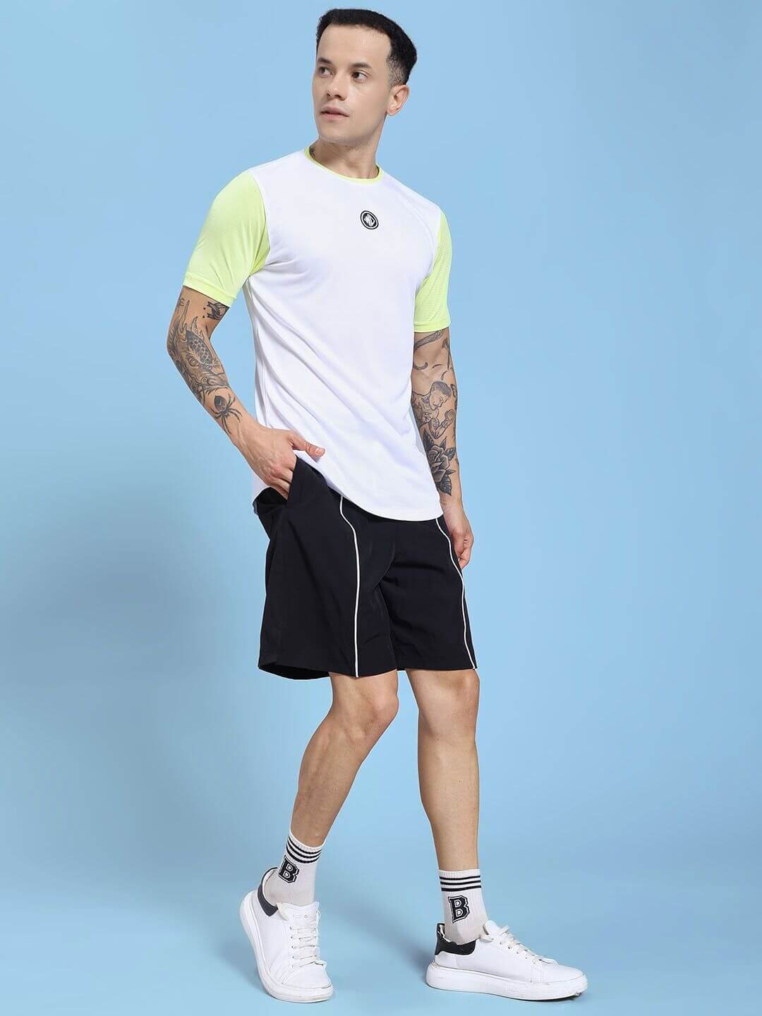 Man wearing CHAMPION ZONE REGULAR FIT CO-ORD SET WHITE NEON BLACK showcasing sporty style with a bold black and white design.