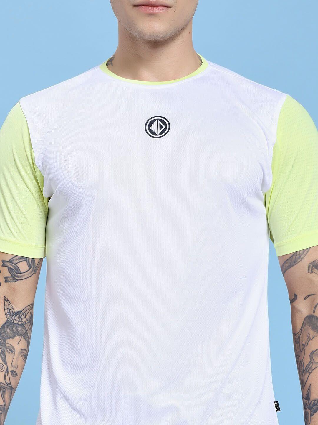 Model wearing CHAMPION ZONE REGULAR FIT CO-ORD SET WHITE NEON BLACK with tattoos showing in a sporty t-shirt.