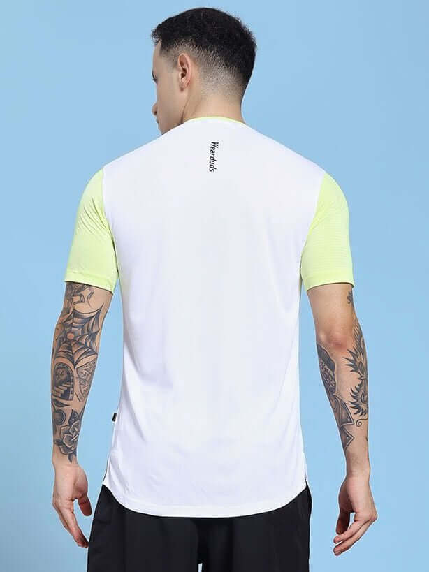 Back view of CHAMPION ZONE REGULAR FIT T-SHIRT WHITE NEON GREEN with neon sleeves worn by tattooed man.
