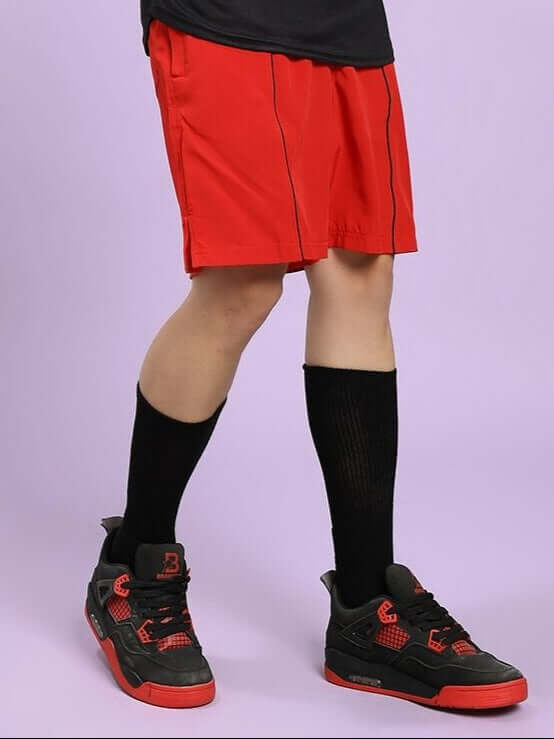 Athlete wearing CHAMPION ZONE FRONT PLATED SHORTS RED, showcasing bold style and comfort for sports and casual wear.
